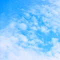 Blue sky with small white fleecy cloud Royalty Free Stock Photo