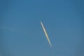 Blue sky with smoke contrail from a rocket or airplane. White cl