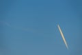 Blue sky with smoke contrail from a rocket or airplane. White cl