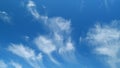 Blue sky soft silky clouds. Background of sky and clouds. Cirrus clouds in blear bright summer day. Time lapse. Royalty Free Stock Photo