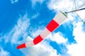 Blue sky and striped windsock