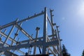 Blue sky and sun over structural steel construction framing