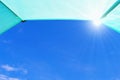 Blue sky with sun rays seen from inside a tent. Royalty Free Stock Photo