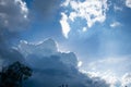 A blue sky with sun, sunbeams and clouds Royalty Free Stock Photo