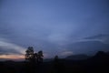 Blue sky at sunset in the mountains. Twilight view with the tree silhouette. Royalty Free Stock Photo