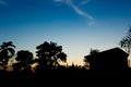 Blue sky sunset with siluate of tree and home