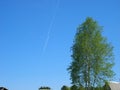 Blue sky with two airplanes and parallel contrail line. High sky background with light fluffy trail line from single airplane