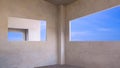 Blue sky view inside of panoramic windows frame on concrete wall room of modern office building structure in construction site Royalty Free Stock Photo