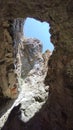 the blue sky is visible through the ruins of an ancient mountain fortress Royalty Free Stock Photo