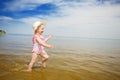 Blue sky, water and running child Royalty Free Stock Photo