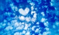 Blue sky of white cirrus,cumulus,layered air clouds,with heart shaped cloud in middle,on beautiful day.Banner for text Royalty Free Stock Photo