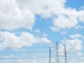 Blue sky and white cloud with high voltage transmission towers and power line the electricity infrastructure Royalty Free Stock Photo