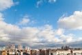 Blue sky with white clouds above roofs of apartment houses Royalty Free Stock Photo