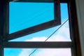 Blue Sky, White Clouds, Black Cables as Seen Looking Up the Open Window Royalty Free Stock Photo