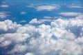 Blue sky, white clouds cover the earth background. Aerial photo from airplane`s window.