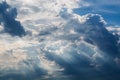 Blue sky with white clouds and curly dark rain clouds. Sky background. Royalty Free Stock Photo