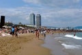 Barcelona beach with casual sun lovers under blue sky