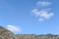 Blue sky with white clouds over mountain range on a sunny day in Andorra Royalty Free Stock Photo