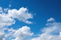 a blue sky with white clouds and a plane flying in the sky with a blue sky in the background and a few white clouds in the sky Royalty Free Stock Photo
