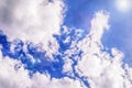 Blue sky with white clouds and sun glare. Sky background. Toned photo Royalty Free Stock Photo