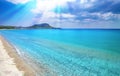 Blue sky, white clouds, sun rays, clear sea water background. Toroni beach, Sithonia, Greece Royalty Free Stock Photo