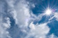 Blue sky and white fluffy clouds flooded with sun, sunlight, refraction Royalty Free Stock Photo