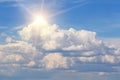 Blue sky with fluffy clouds and sun, sunlight, yellow sun rays on heaven Royalty Free Stock Photo