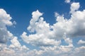 Blue sky with white fluffy clouds on a sunny day, cumulus, cloudscape background Royalty Free Stock Photo