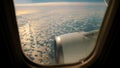 Blue Sky and white fluffy Clouds View from above through airplane's window at sunrise Royalty Free Stock Photo
