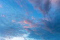 Blue sky with white pink clouds at sunset before rain. Royalty Free Stock Photo