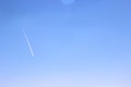 Blue sky and white trace of a plane flying high Royalty Free Stock Photo