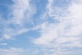 Blue sky with windy clouds. Natural background photo texture taken on sunny day. Cirrus type of clouds