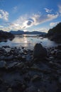 Blue sky and wispy clouds reflected in calm bay at low tide, Brookes Peninsula