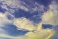 Blue sky with yellow fluffy clouds