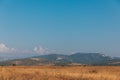 blue sky yellow grass mountains in the distance nature Royalty Free Stock Photo