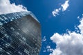 Blue skyscraper with reflections of clouds on windows Royalty Free Stock Photo