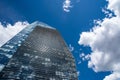 Blue skyscraper with reflections of clouds on windows Royalty Free Stock Photo