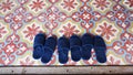 Blue slippers on vintage asian art floor tiles. Royalty Free Stock Photo