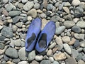 Blue slippers for walking on pebbles. Pebbles shoes men\'s slip-on sneaker, waterproof breathable. Pebble summer beach Royalty Free Stock Photo