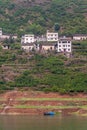 Blue sloop on brown shoreline, Xiling Gorge, Shengli Street, China