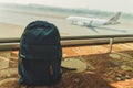 Blue small backpack standing on the floor at the airport