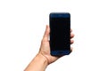 Blue smartphone with a black screen in a female hand isolated on white background with space for text Royalty Free Stock Photo