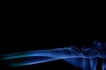 Blue smoke on a black background, abstract smoke swirls