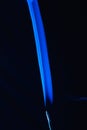 Blue smoke incense stick on black background