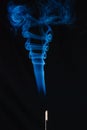 Blue smoke incense stick on black background Royalty Free Stock Photo