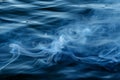 blue smoke over water creating a wave effect Royalty Free Stock Photo