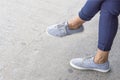 Blue sneakers on asian female feet. Royalty Free Stock Photo