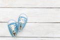 Blue sneakers for a little boy on a white wooden background. Mock up Royalty Free Stock Photo