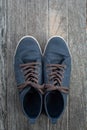 Blue Sneakers on Old Wood Background Royalty Free Stock Photo