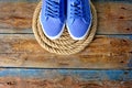 Blue sneakers shoes on a rope spiral